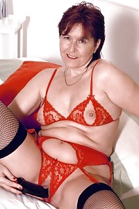 Kirsty Poses In Her Shining Silver Stockings And Purple Undie On The Table